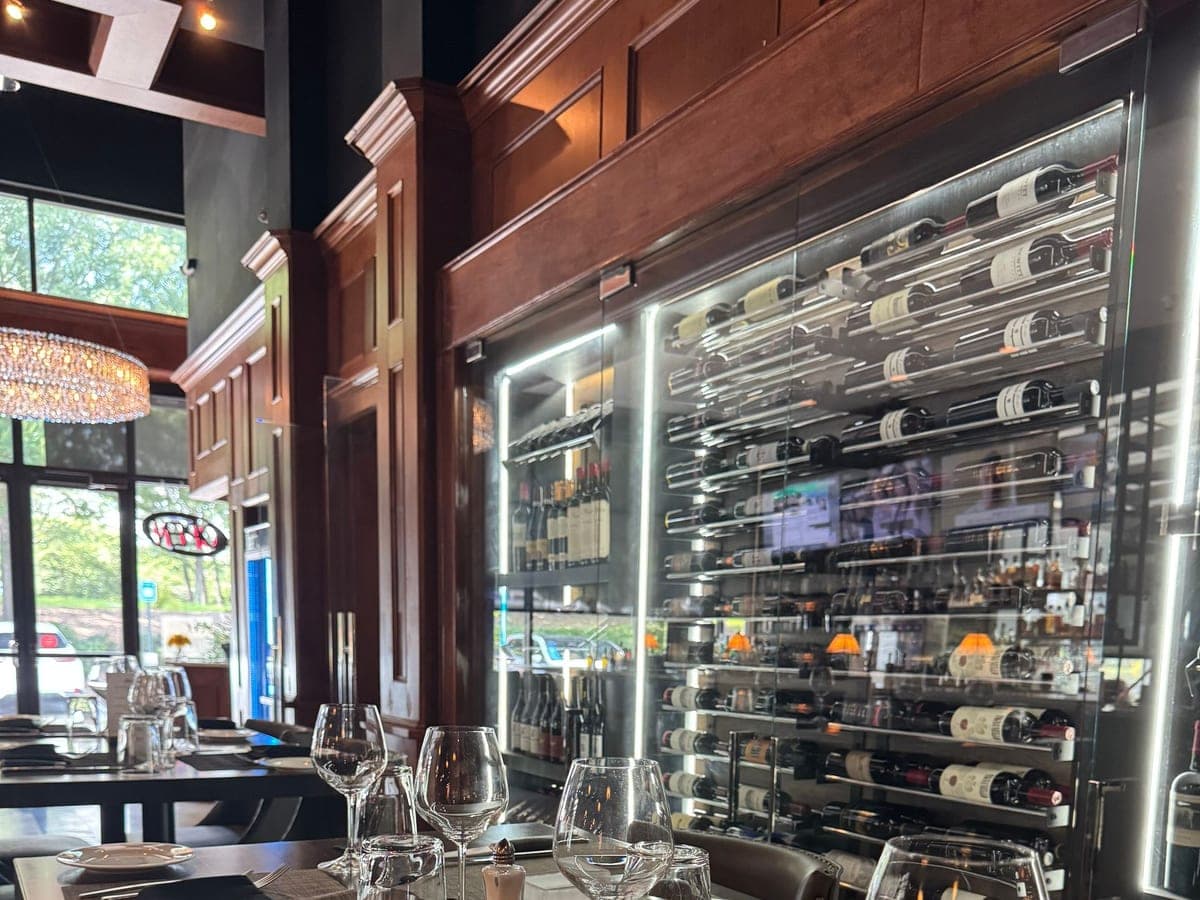 The wine wall at Luci's, bottles racked floor to ceiling behind glass
