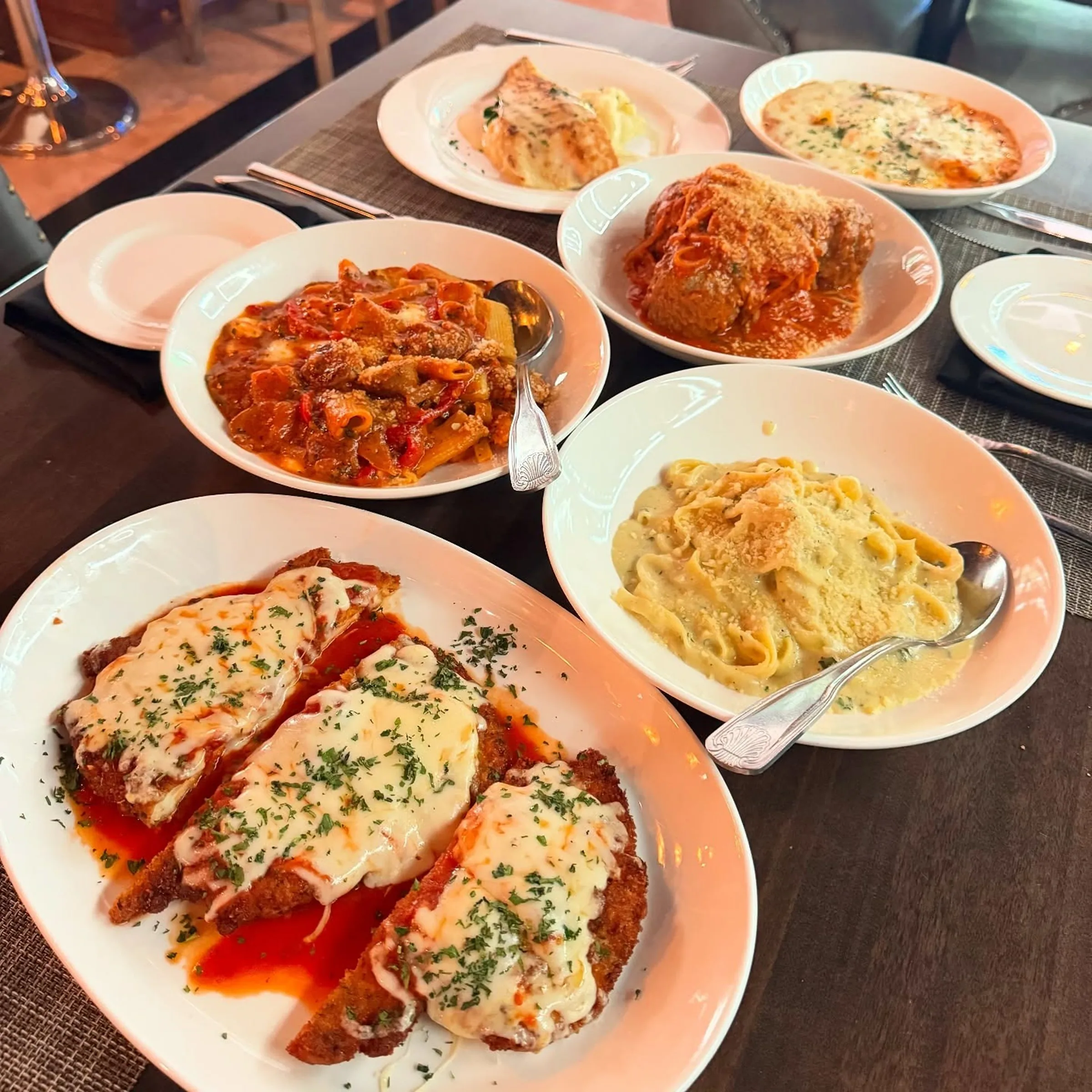 Chicken parmigiana, pasta and meatballs served family style